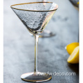 organic cocktail martini glass with gold rim